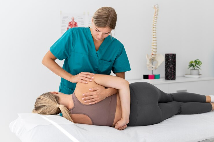 physiotherapist-helping-patient-her-clinic_23-2149115653